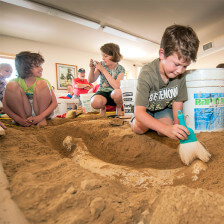 Child at interactive exhibit of the Mammoth Site in Hot Spring, South Dakota