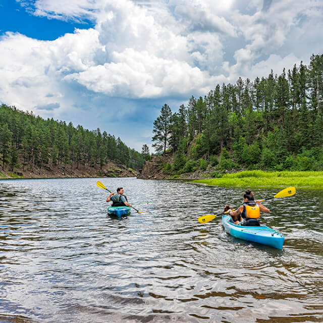 Kayakers in Pactola Lake in the Black Hills National Forest of South Dakota