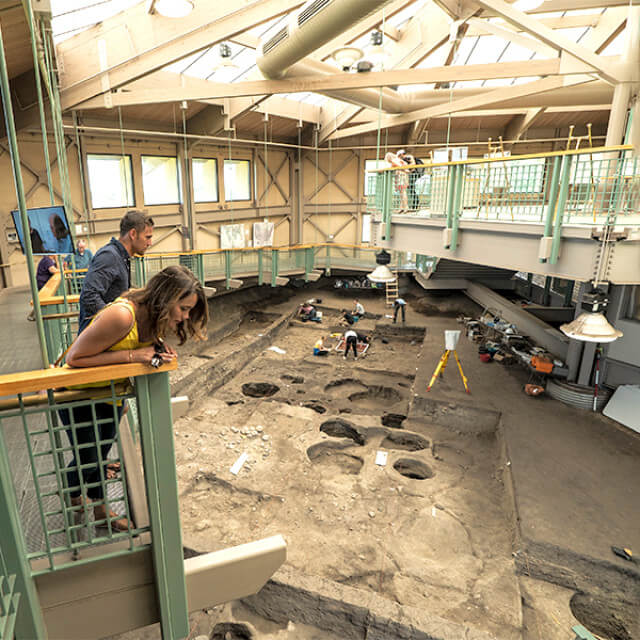 Visitors observing active digging at Mitchell Prehistoric Indian Village in South Dakota